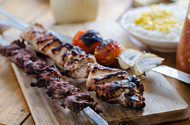 Kazam's Special Chelo Ghafghazi: Chicken and tenderloin kebab served with buttered rice and grilled tomatoes and onions.